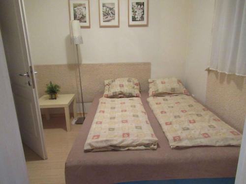 a small bedroom with two beds and a table at Apartment in Csopak - Balaton 54882 in Csopak