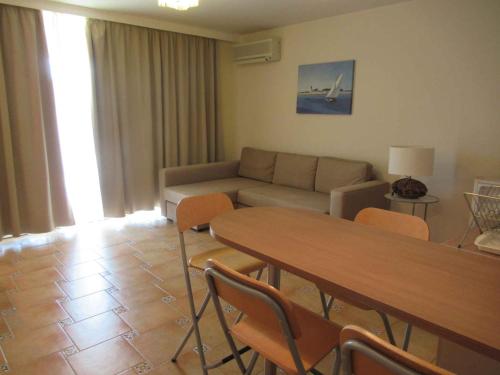 a living room with a couch and a table and chairs at Apartment in Csopak - Balaton 54882 in Csopak