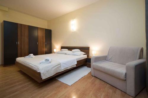 a hotel room with a bed and a chair at Apartment in Crikvenica 41676 in Sopaljska