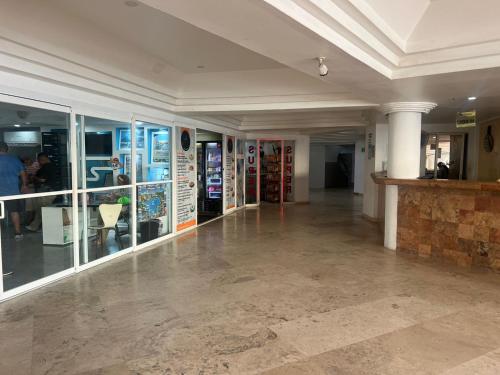 a large room with a lobby withwindows and a stone floor at Suite con acceso a playa y vista espectacular in Acapulco