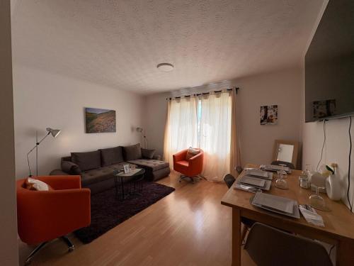 a living room with a couch and a table at Misk Homes #3 Near Heathrow Airport, shops & Brunel University - Free Parking in Uxbridge