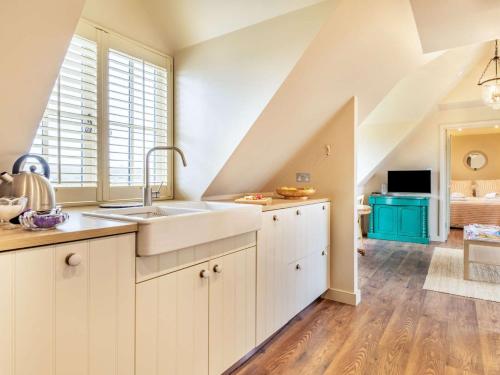 a kitchen with white cabinets and a sink at 1 Bed in Horsham 86961 in Rudgwick