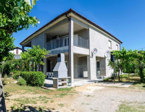 a large white building with a large balcony at Apartments in Lopar - Insel Rab 26467 in Lopar