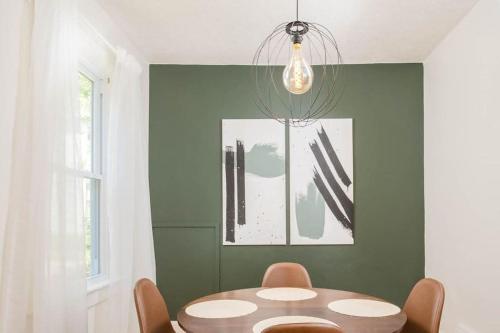 a dining room with a table and a chandelier at Downtown Walkable - 2 bed 1 bath King Bed in Appleton