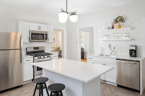 a kitchen with white cabinets and a white counter top at Downtown Walkable - 2 bed 1 bath King Bed in Appleton
