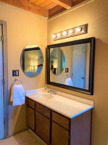 a bathroom with a sink and a large mirror at Summit County Wildernest Condo in Silverthorne