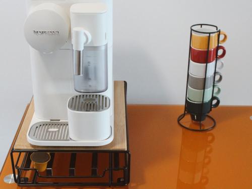 a white blender sitting on top of a table at Madeira Home at Cliff Residence in Santa Cruz