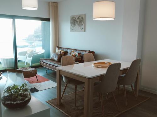 a living room with a table and a couch at Madeira Home at Cliff Residence in Santa Cruz
