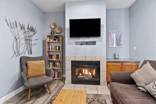 a living room with a fireplace and a tv at Peaceful Palace in Oceano