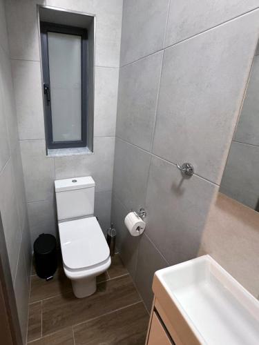a bathroom with a toilet and a sink and a mirror at Mini Studios in Central Victoria in Victoria