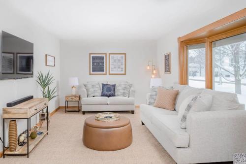 a living room with two couches and a table at Stevens Point Getaway - HUGE 5 bedroom Home 3 Full Bath in Stevens Point