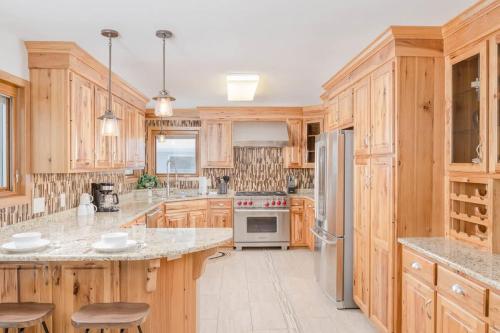 a large kitchen with wooden cabinets and a stove top oven at Stevens Point Getaway - HUGE 5 bedroom Home 3 Full Bath in Stevens Point
