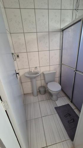 a small bathroom with a toilet and a sink at Apartamento pequeno central in Santa Vitória do Palmar