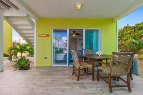 a patio with a table and chairs in a house at The Turtle Nest at Cottages in Sand Bluff