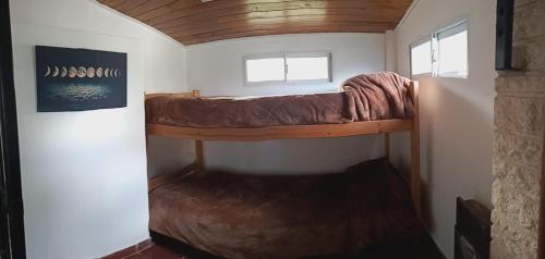 a room with a bunk bed in a tiny house at La perla del mar in Mar del Plata