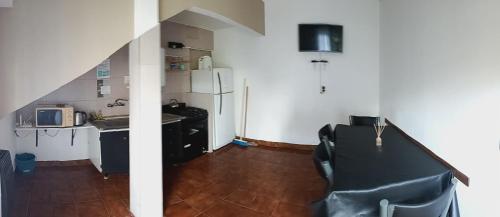 a small kitchen with a sink and a refrigerator at La perla del mar in Mar del Plata