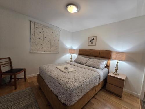 a bedroom with a bed with a tray on it at Central Two Bedroom Apartment Near Union Square -Free Parking in Aberdeen
