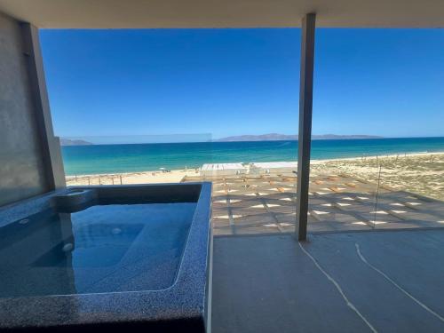 a swimming pool with a view of the beach at Private jacuzzi Ocean View Condo in La Ventana
