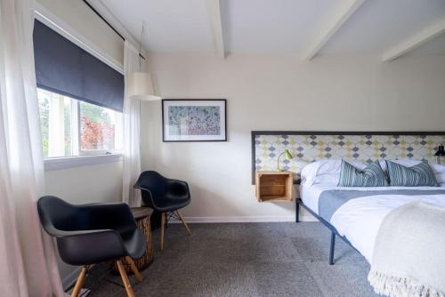 a bedroom with a bed and two chairs at The Billy Motel Pet Friendly Room with Charm in Davis
