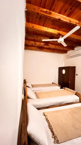 a row of beds in a room with a ceiling at Wanasa House in Dahab
