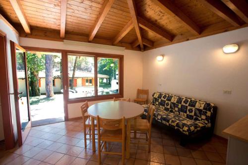 a living room with a table and a couch at Mobilehome in Belvedere Grado 53452 in Belvedere
