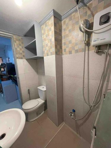 a bathroom with a shower and a toilet and a sink at Big Beautiful House in Pasig in Manila