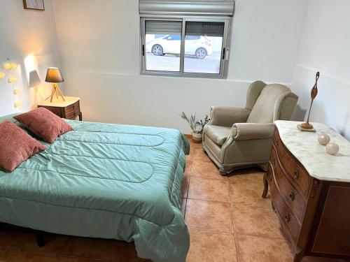 a bedroom with a bed and a couch and a chair at Casa, gran parrillero a pocos minutos de sitios turísticos in Minas