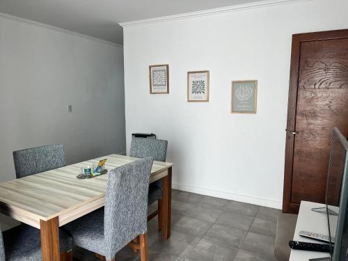 a dining room with a wooden table and chairs at Hermoso PH en Necochea playa in Necochea