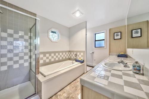 a bathroom with a tub and a sink at Minnow's Run in Brockway Vista