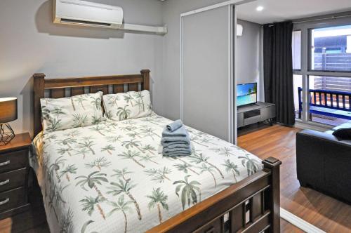 a bedroom with a bed and a tv in a room at Stylish Studio 1x1 Walk to CBD in Port Hedland