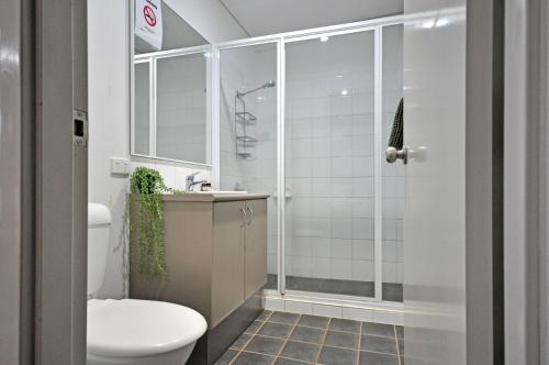 a bathroom with a shower and a toilet at Stylish Studio 1x1 Walk to CBD in Port Hedland