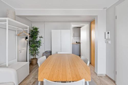 a dining room with a wooden table and chairs at Modern Limpertsberg Studio Near City Center in Luxembourg