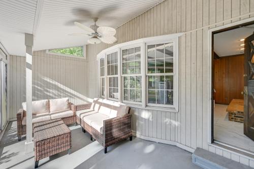 a porch with wicker chairs and a ceiling fan at Private Pool and Home Theater Buchanan Family Home! in Buchanan