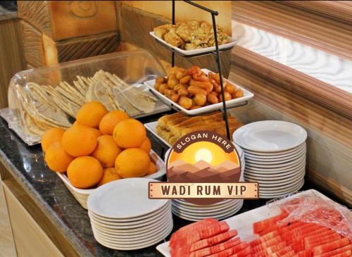 a buffet with plates of food on a counter at WADI RUM NEOM lUXURY CAMP in Wadi Rum