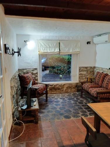 a living room with two couches and a television at Casa alameda in Mar de Cobo