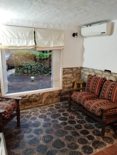 a living room with two couches and a window at Casa alameda in Mar de Cobo