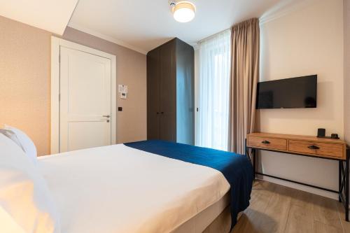 Llit o llits en una habitació de Invictus Hotel