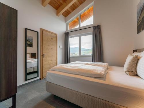 een slaapkamer met een groot bed en een raam bij Grebenzen Lodge Starnberg 60B in Sankt Lambrecht