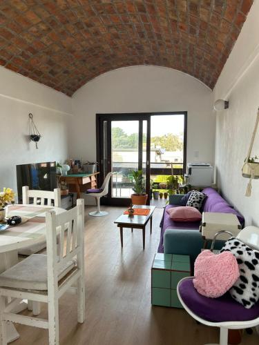 a living room with a couch and a table at aba casa estudio in Pinamar