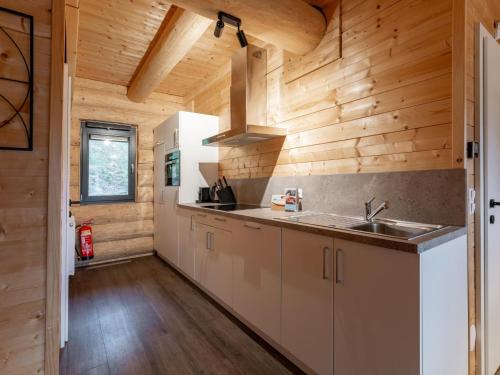 a kitchen with a sink and wooden walls at Jenig 1A in Jenig
