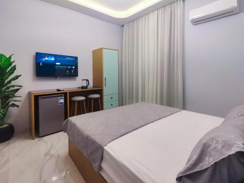 a bedroom with a bed and a flat screen tv at maravilla downtown cairo in Cairo