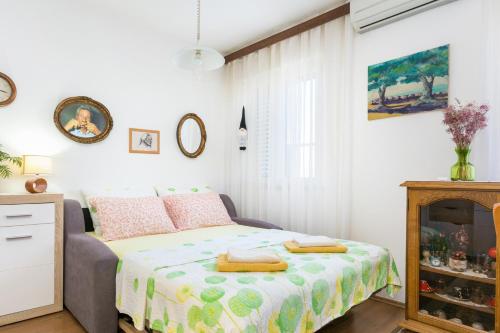 a small bedroom with a bed and a fireplace at Apartments with parking space Mirca, Brac - 729 in Supetar