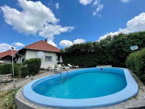 a swimming pool in front of a house at House and Apt in Keszthely Balaton 19032 in Keszthely