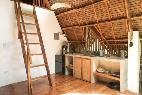 a kitchen with a ladder in a room at Pahinga Villas Siargao in Libertad