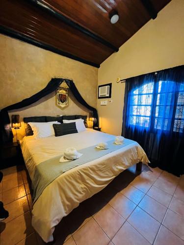 a bedroom with a large bed with two towels on it at Giprita Wellness Hotel Ubatuba in Ubatuba