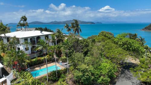 an aerial view of a house and the ocean at Shutehaven Beach House in Shute Harbour