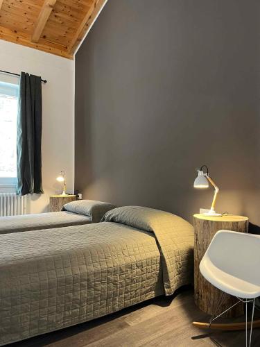 a bedroom with two beds and a table and a lamp at Apartments in Pur - Ledrosee 22640 in Pur