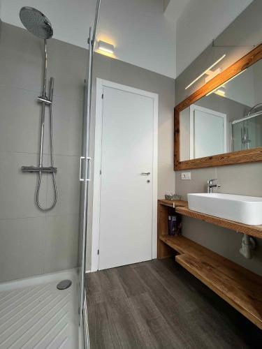 a bathroom with a shower and a sink and a mirror at Apartments in Pur - Ledrosee 22640 in Pur