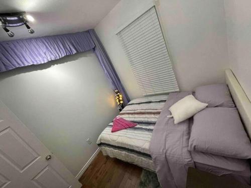 a small bedroom with a bed and a window at Cherry Berry Niagara Falls in Niagara Falls