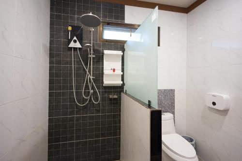 a bathroom with a shower and a toilet at Bang Po Hut in Ban Bang Po